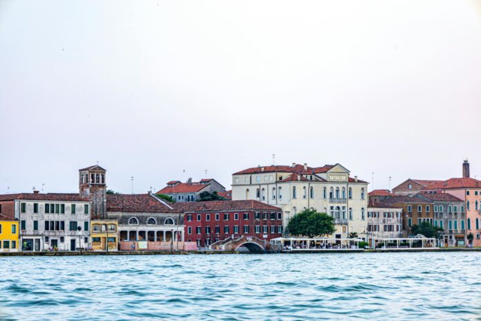 Gondolas floating through the canals of Venice, Italy – The city built on water