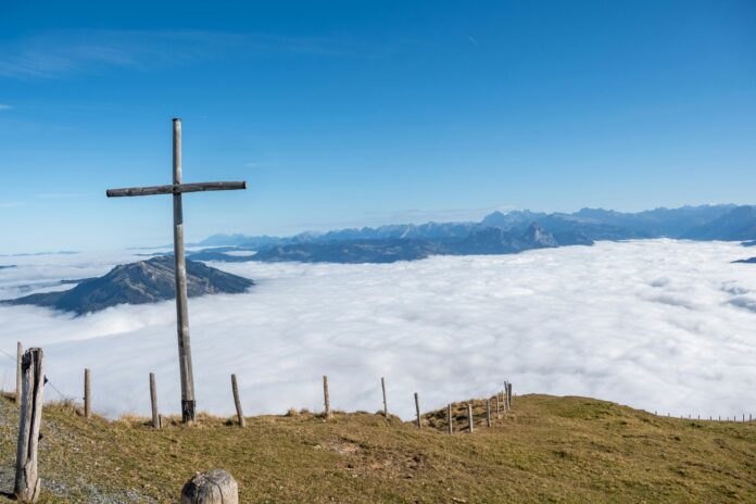 Scenic view of the Swiss Alps with snow-capped mountains, alpine meadows, and crystal-clear lakes.